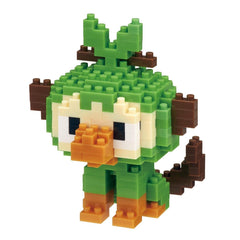 A pixelated toy resembling a monkey or a bird, composed of small green and brown blocks, is shown against a white background.