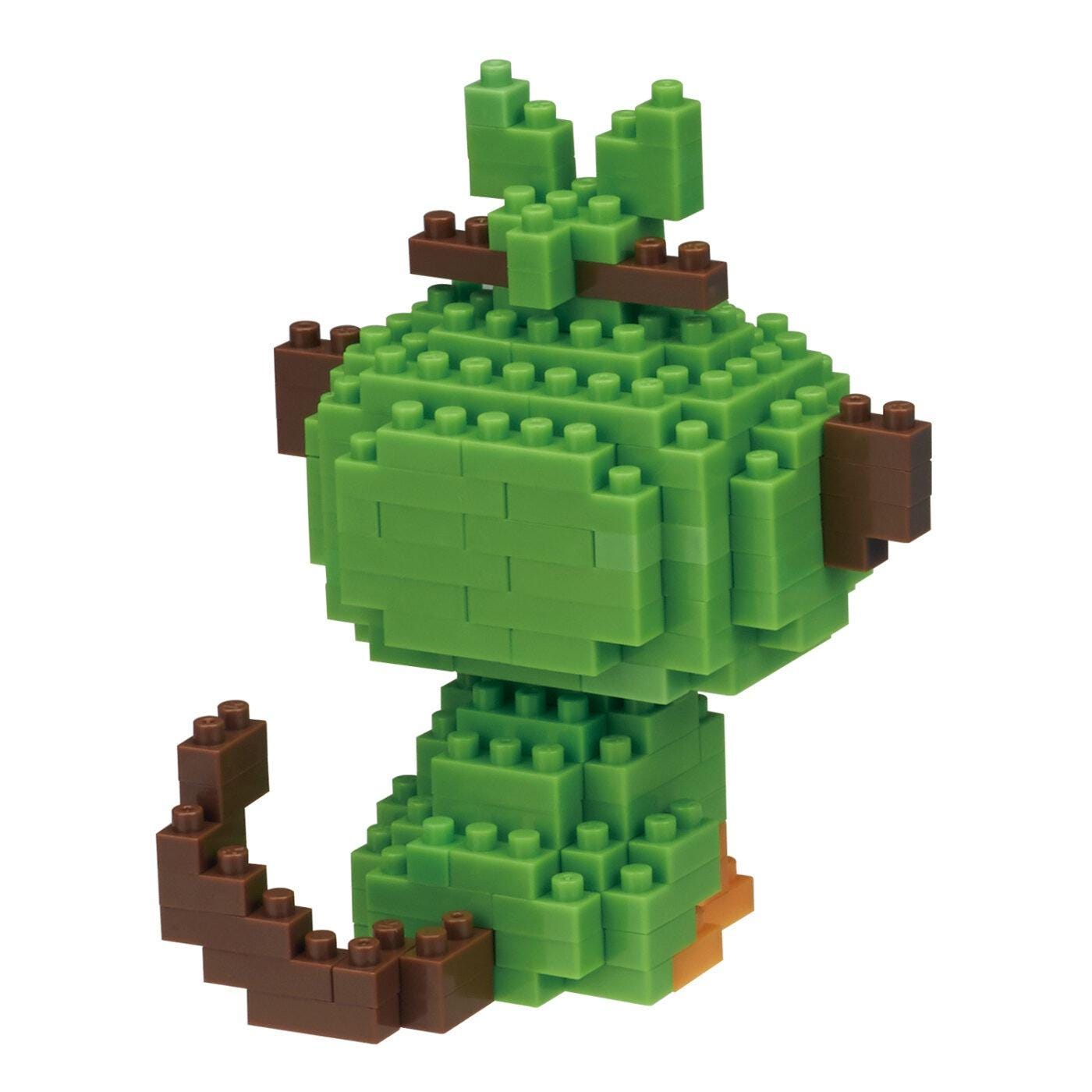 A green Lego figure made up of numerous small Lego bricks.