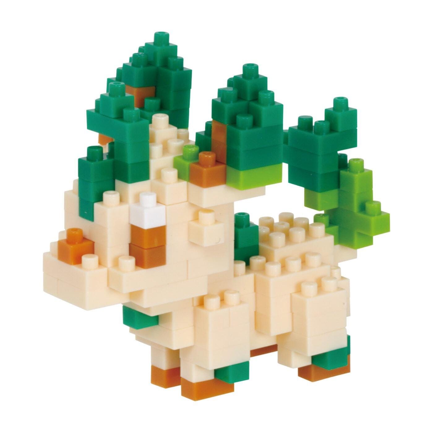 A colorful, geometric toy made of small, interlocking plastic blocks in various shades of green, orange, and white.