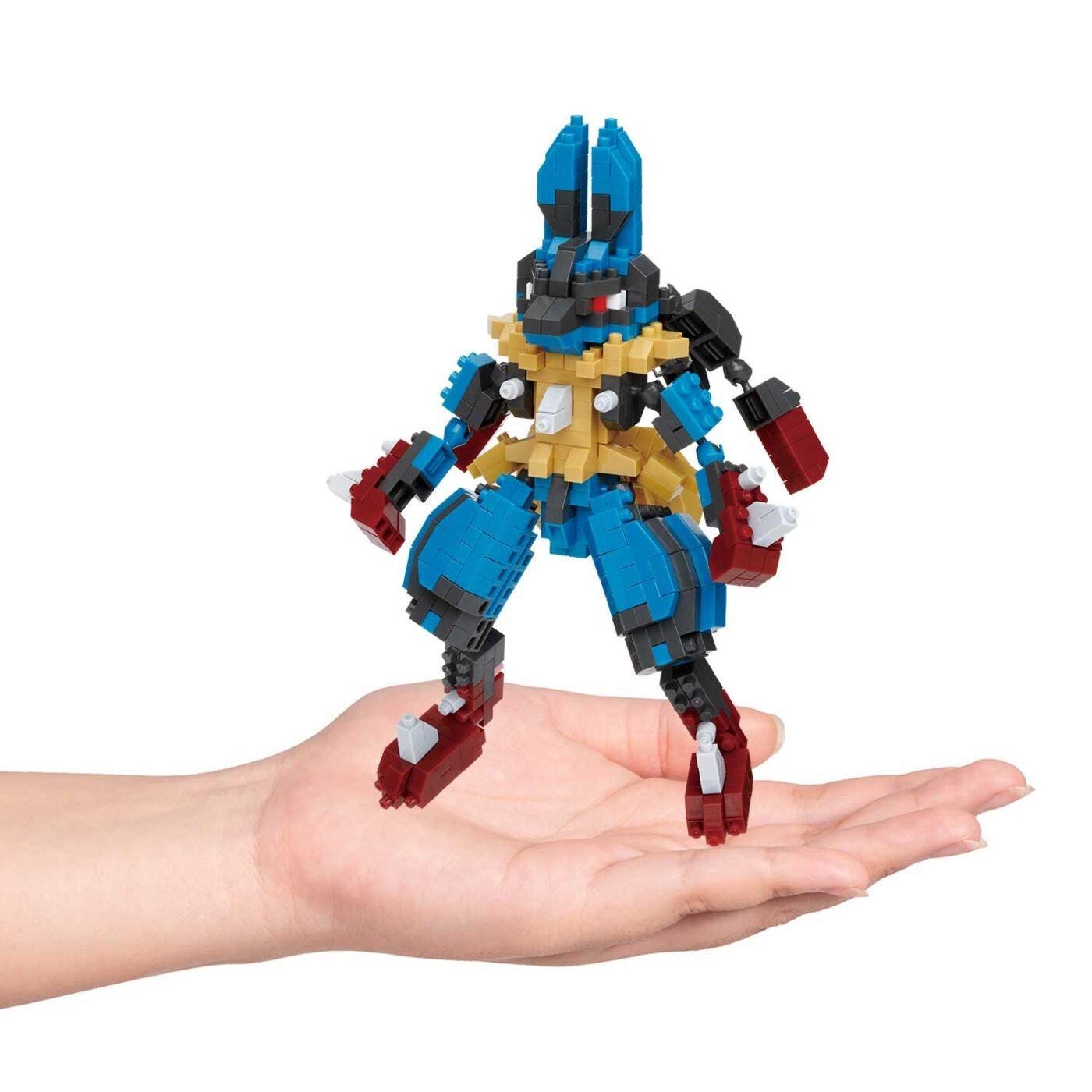 A hand holding a colorful, 3D-printed Lego figure.