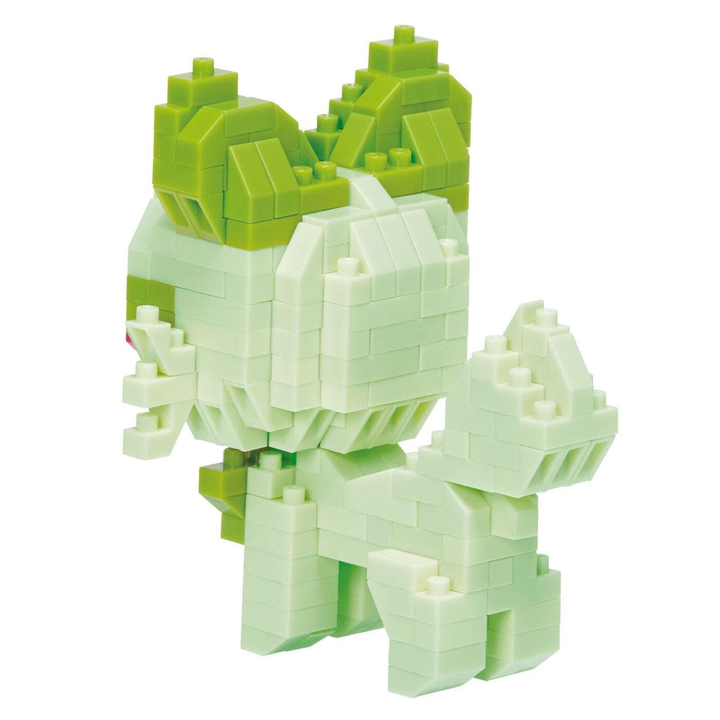 A white and green 3D building block figure, resembling a small animal or creature, is shown in the image.