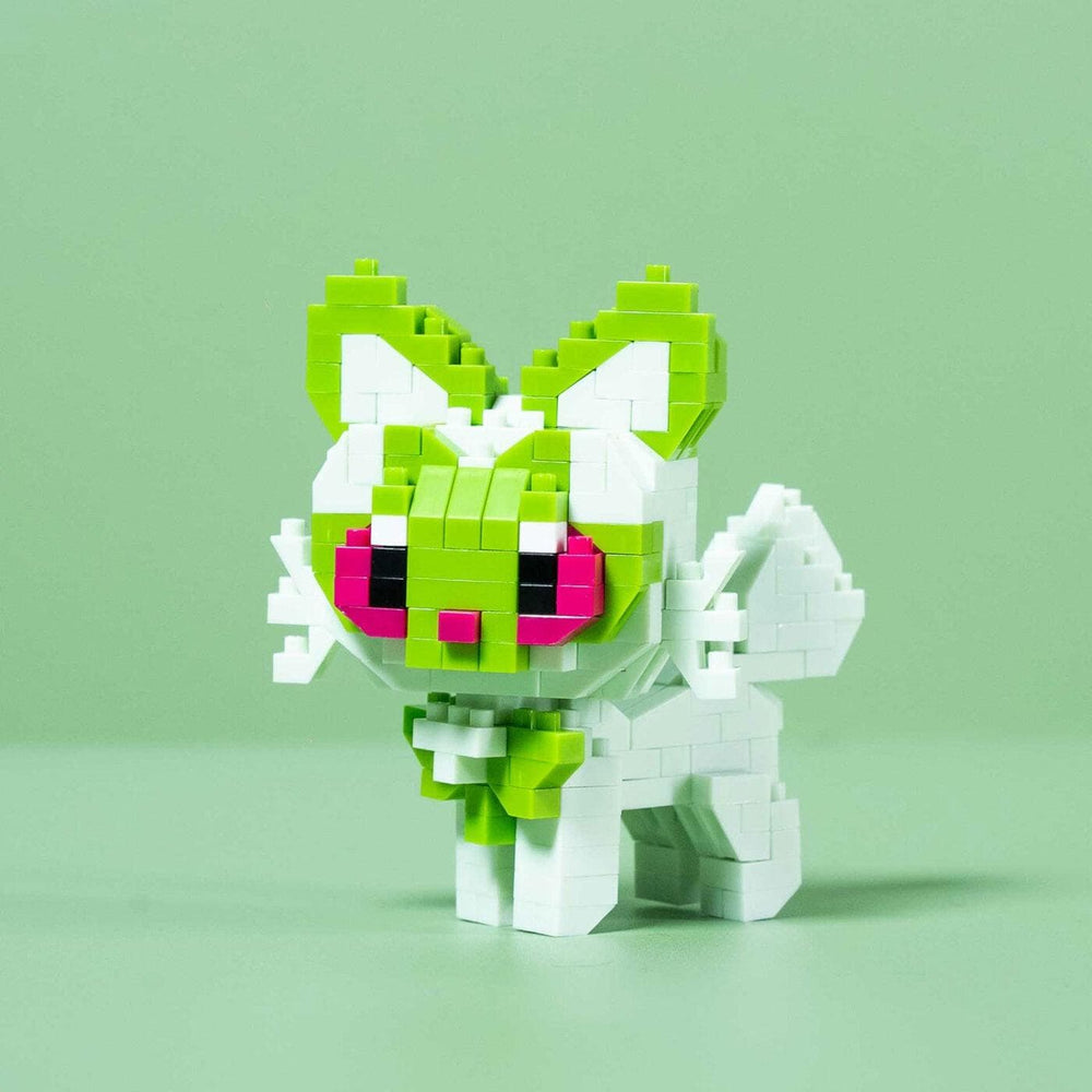 A small, colorful, pixelated toy cat made of small blocks in shades of green and pink.
