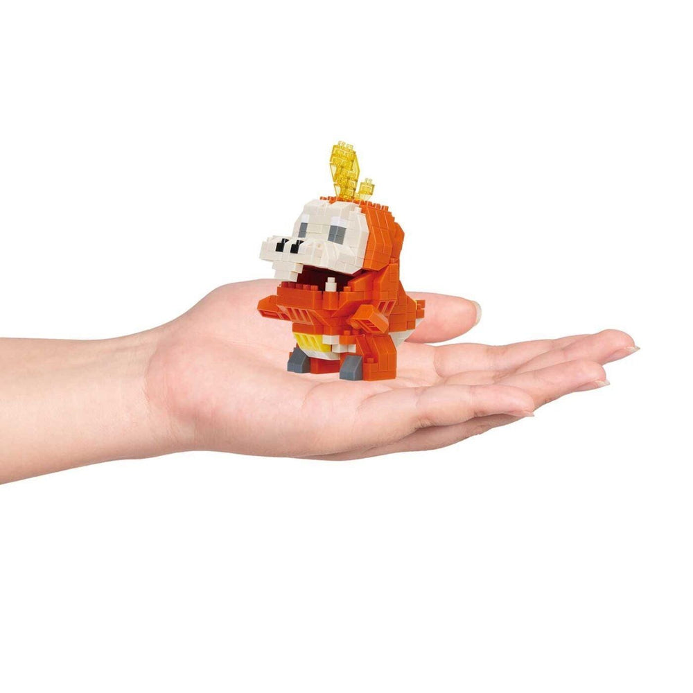 A hand holding a small, colorful, and intricate toy made of small, colorful building blocks.