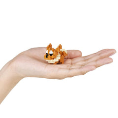 A hand holding a small, pixelated dog-like figure.