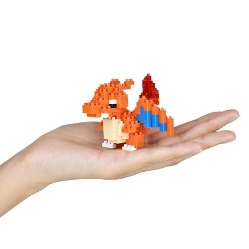 A hand holding a small, colorful, pixelated Pokemon character.