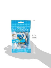 A hand holding a package of Pokémon-themed building blocks.