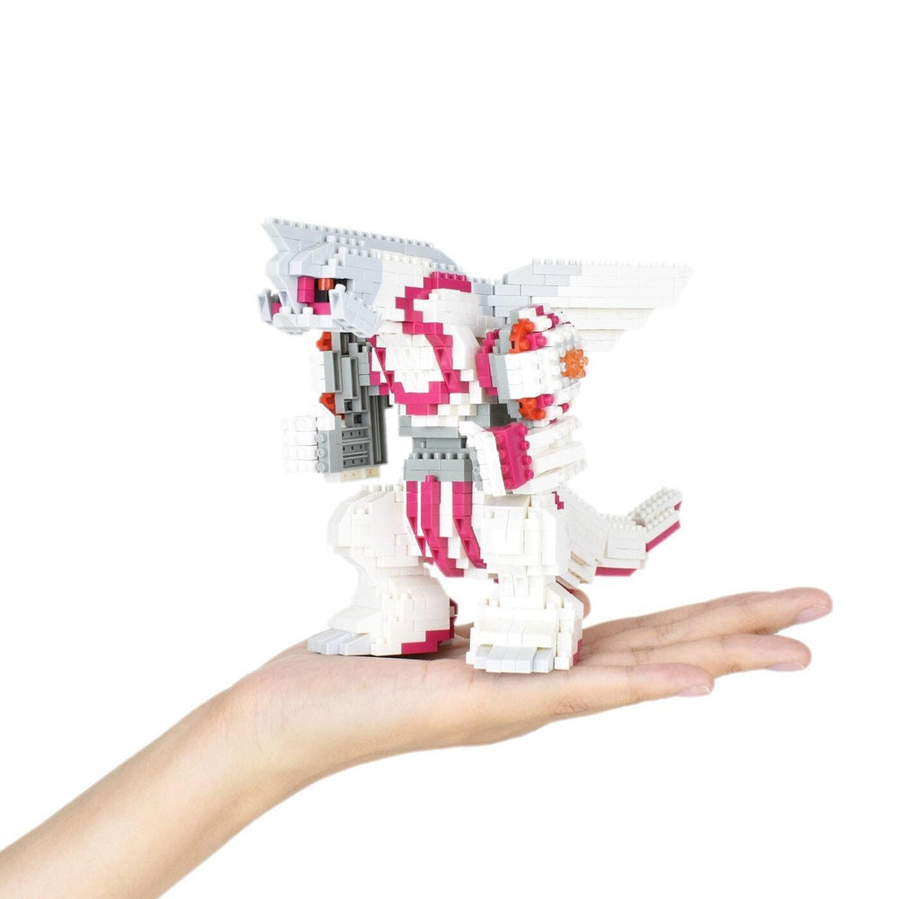 A hand holding a small, colorful, and intricate toy made of small building blocks.