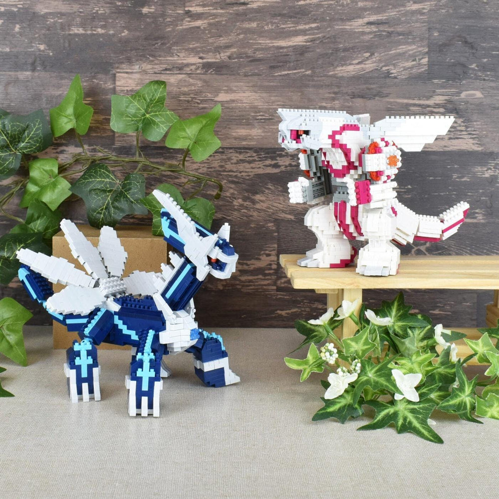 two LEGO figures, one in blue and the other in white, standing on a wooden surface. There are also some plants and flowers in the background.