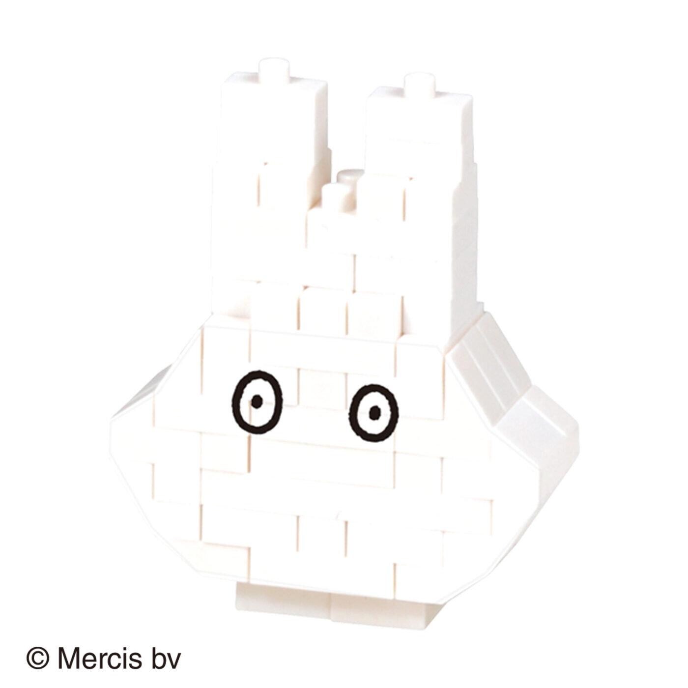 A white, block-like object with two black circles on its eyes, resembling a simple geometric shape or a toy-like structure.