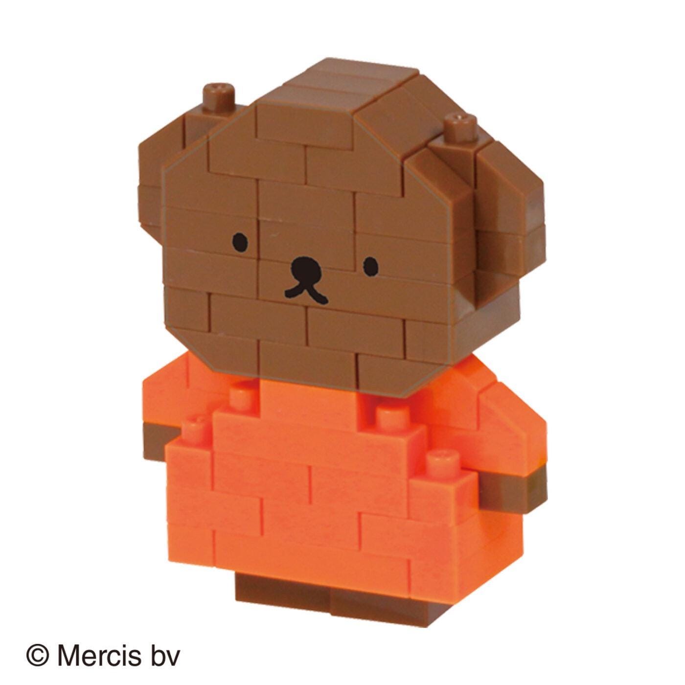A brown bear-shaped block toy with an orange shirt.