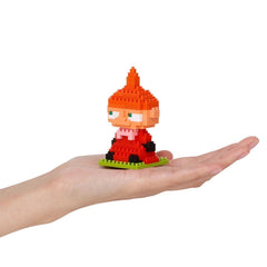 A hand holding a small, colorful, pixelated toy figure in the palm of the hand.