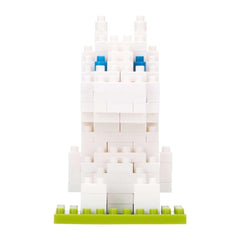 A white Lego bunny with blue eyes is sitting on a green base.