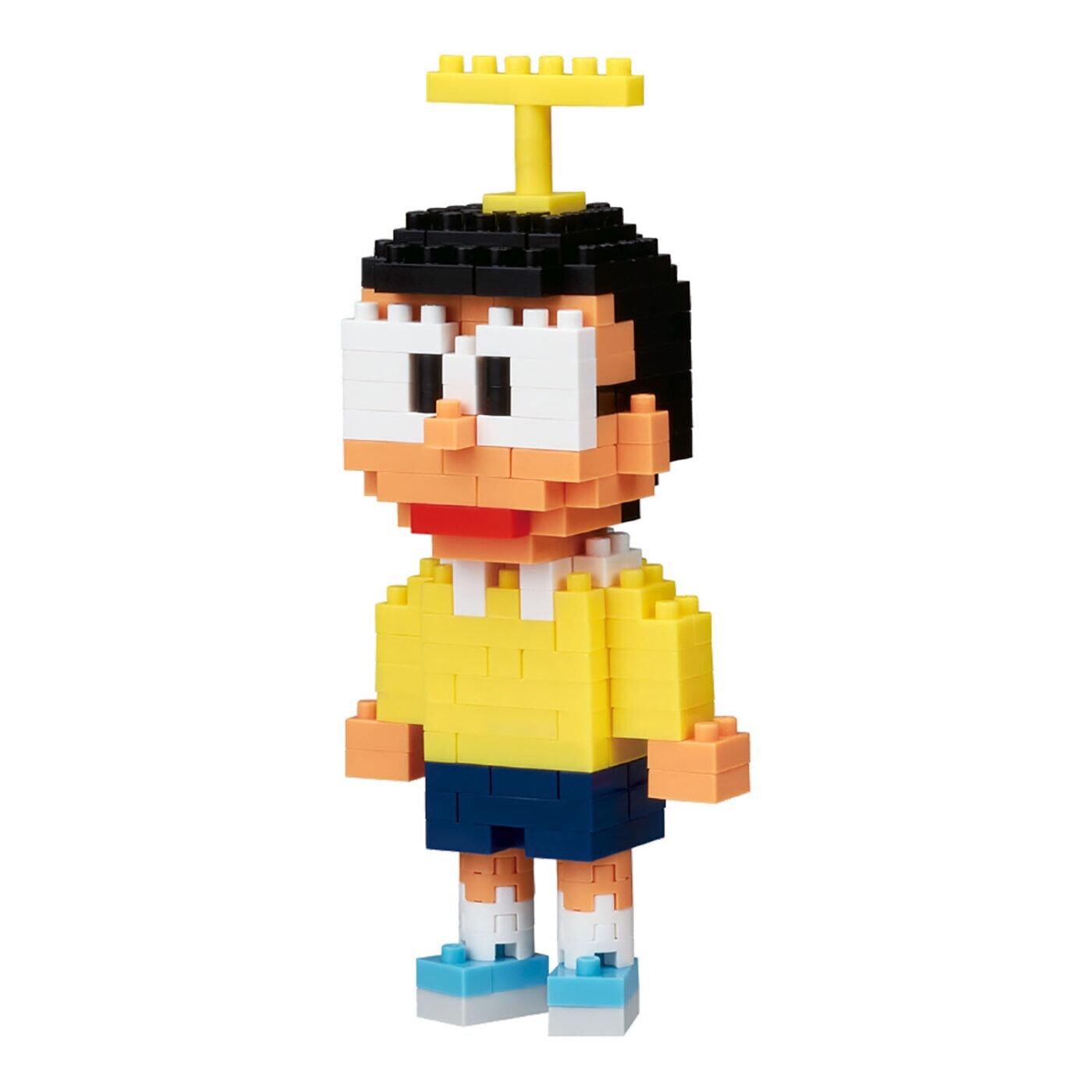 A pixelated toy figure of a young boy wearing a yellow shirt and blue shorts, with a yellow crown on his head.