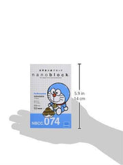 A hand holding a blue and white item labeled "NBB 074" with a cartoon character on it.