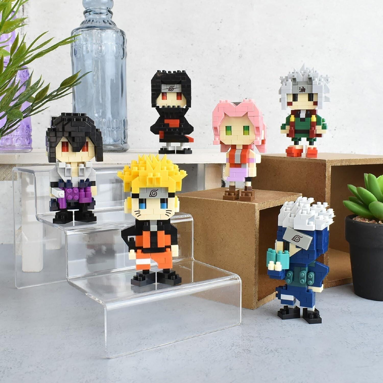 A collection of six colorful, pixelated figurines or characters, each with unique features and designs, displayed on a shelf or table.