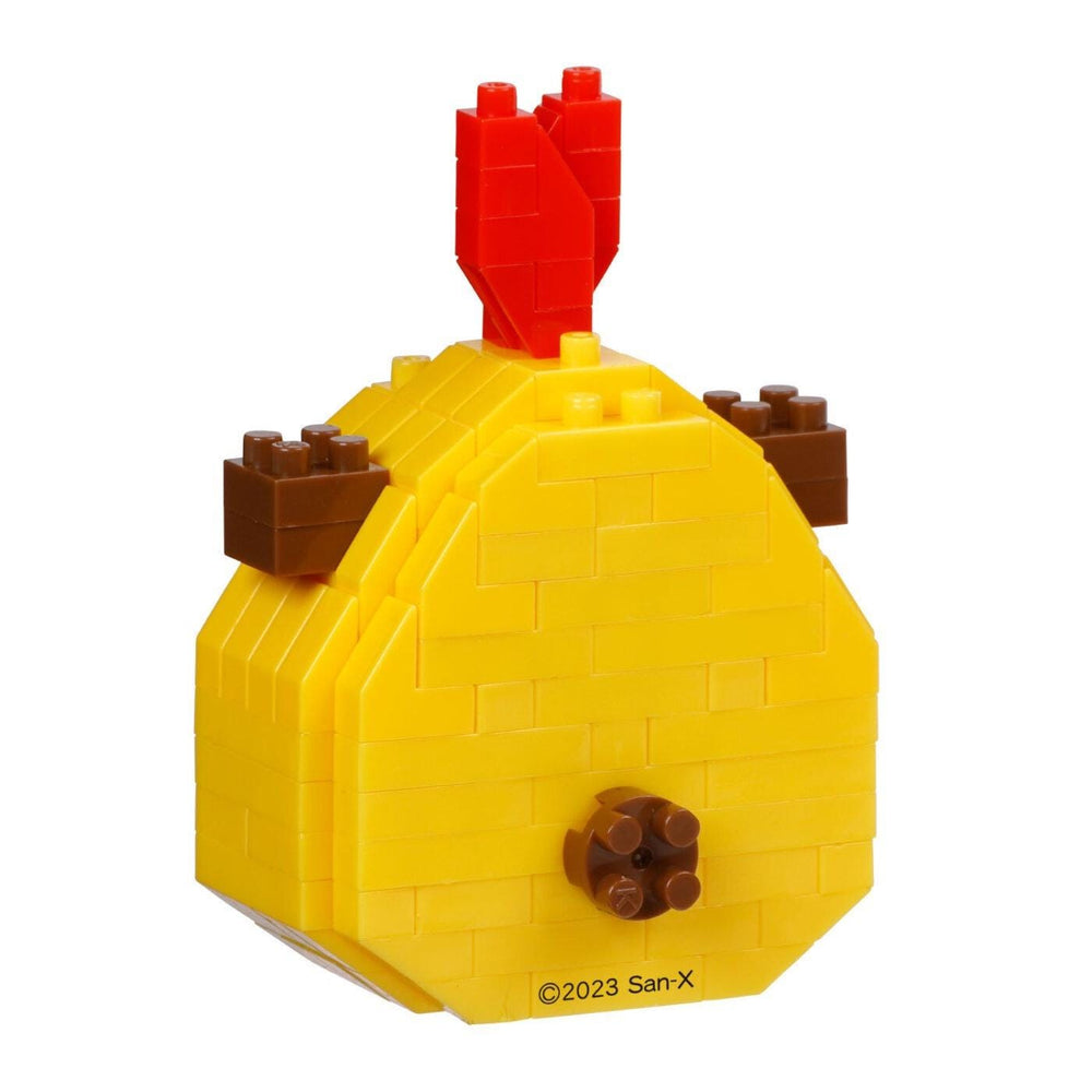 A yellow and red toy, resembling a building block or Lego structure, with a red piece on top and brown pieces on the sides.