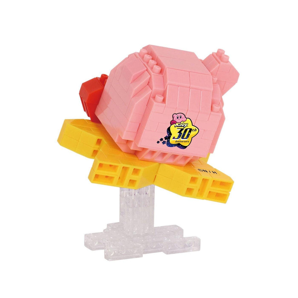 A pink and yellow toy figure with a yellow star on its back, sitting on a clear plastic stand.