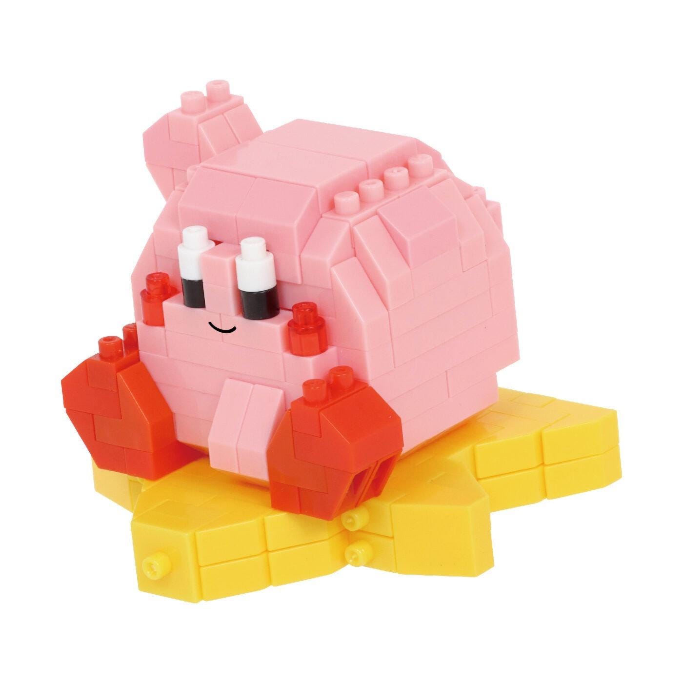 A pink and yellow building block toy with a smiling face and red and orange accessories.