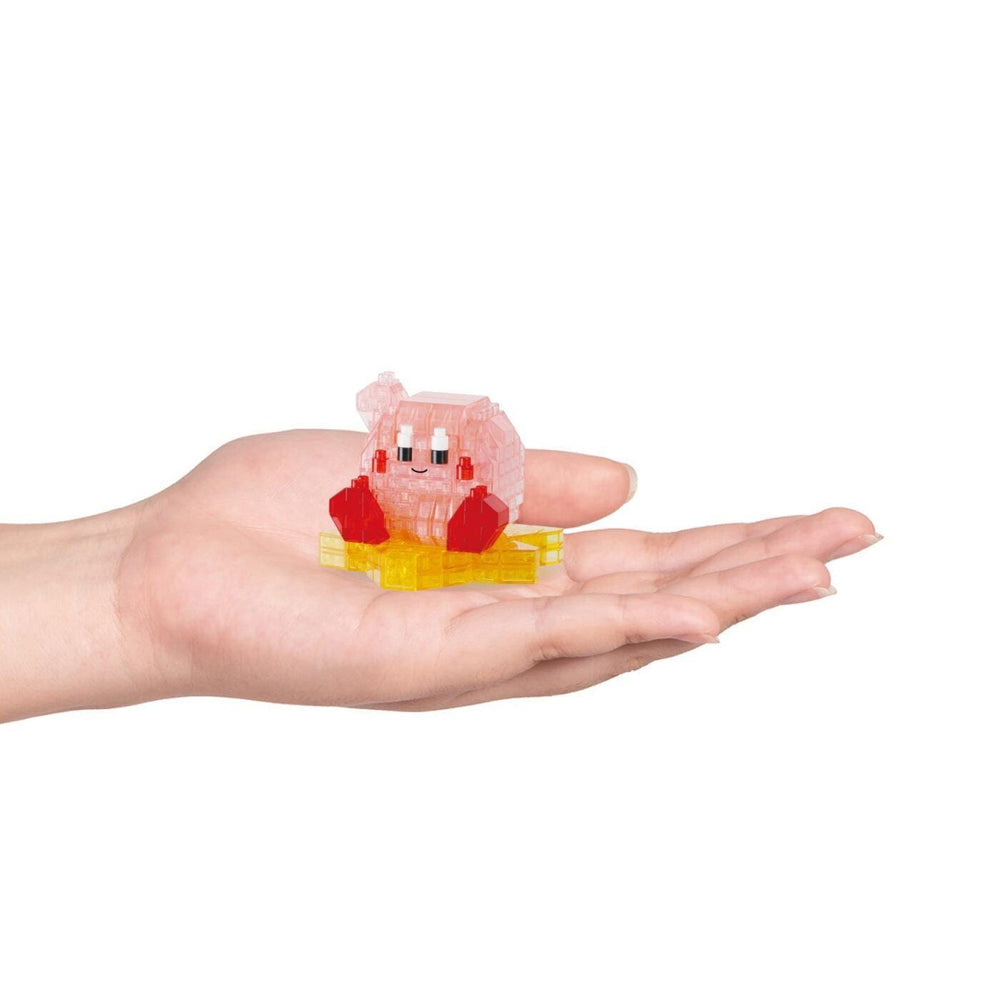 A hand holding a small, colorful toy in a pink and yellow shape.