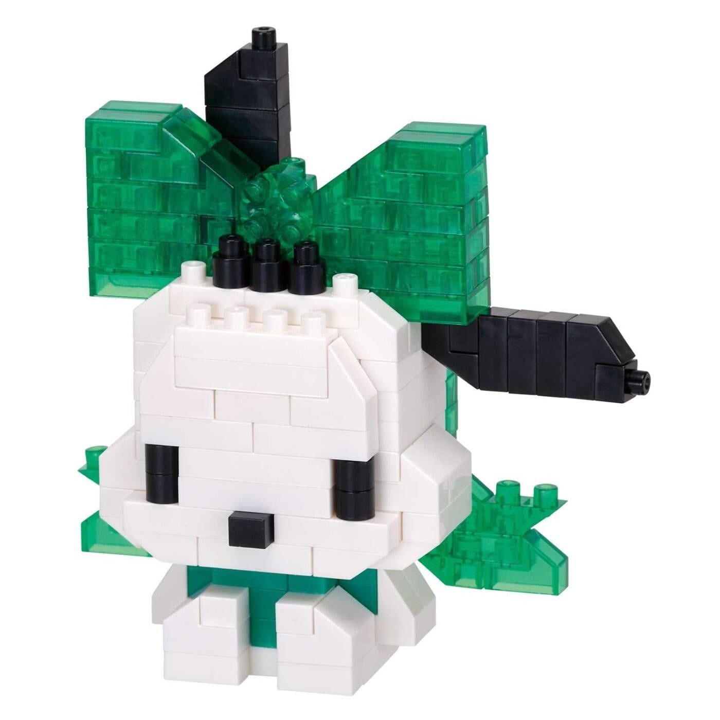A white and green building block toy resembling a cat or bunny, with a black and green bow on its head.