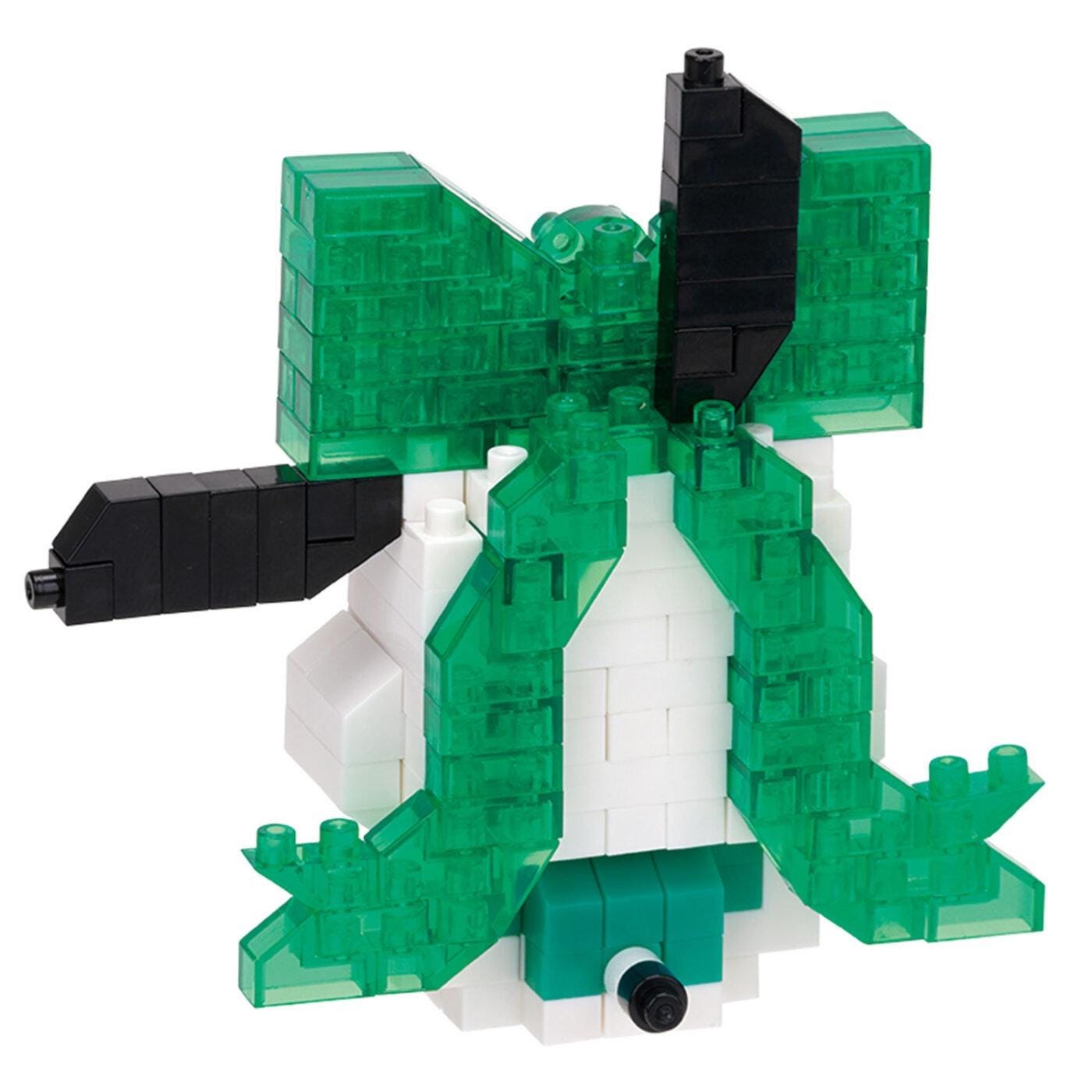 A green and white toy robot made of building blocks.