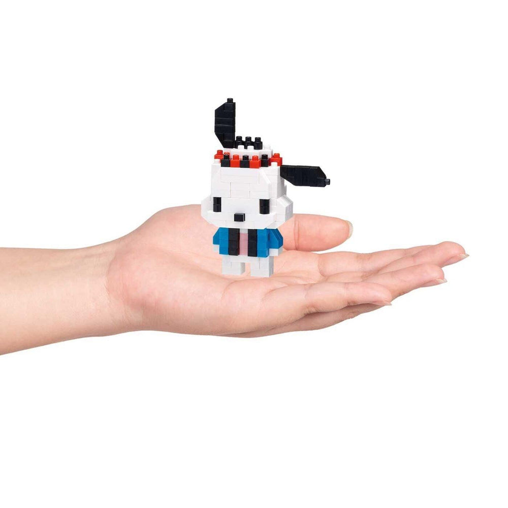 A hand holding a small, white and blue pixelated character.