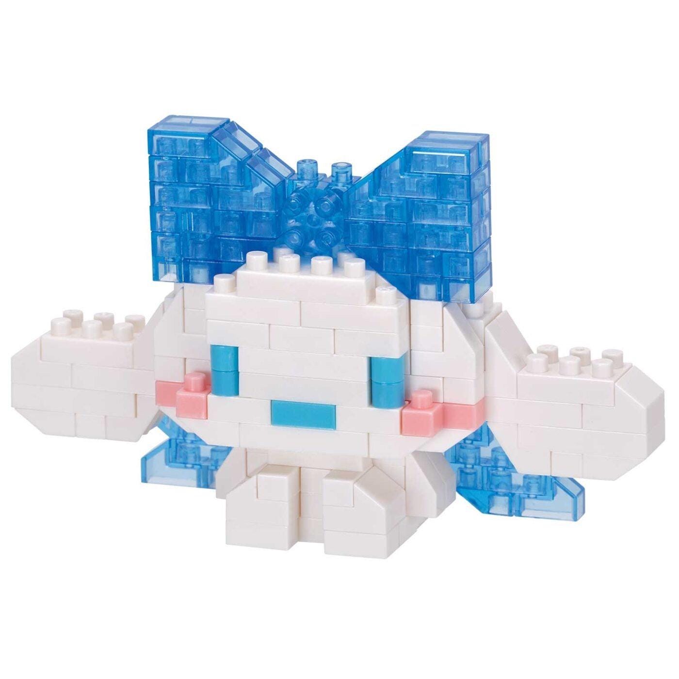 A white and blue building block toy with a bow on top, sitting on a white background.