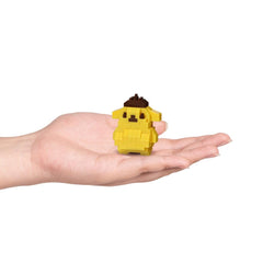 A hand holding a small yellow pixelated character, likely a pixelated dog or cat, against a white background.