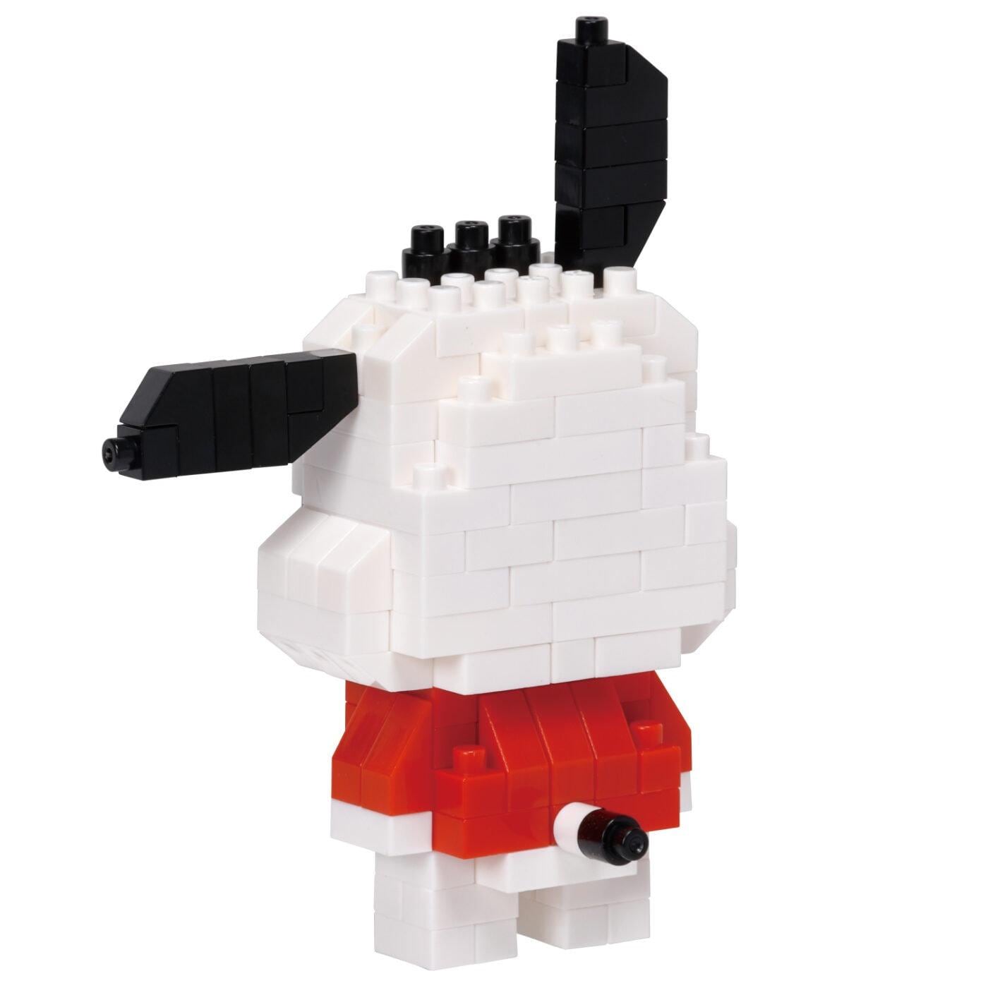 A white and black building block figure resembling a dog or a bear, with a red shirt and black ears.