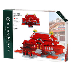 The image is a box containing a Nanoblocks Shurik Castle building block set. The box features a picture of the completed castle and includes text and logos related to the product.