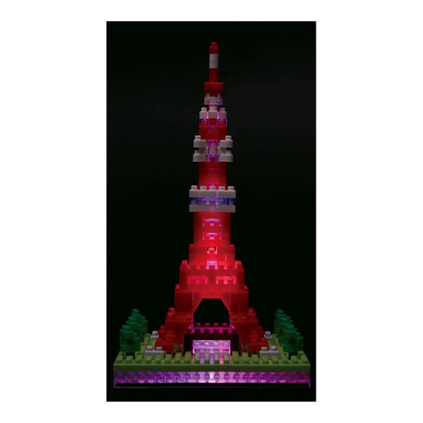 A colorful, illuminated Lego tower stands against a dark background.