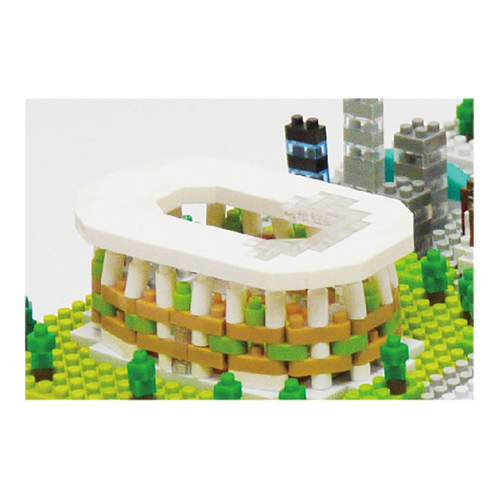 A miniature model of a stadium made of Lego bricks, with a white roof and green and yellow accents.