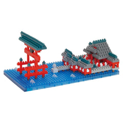 A colorful toy model of a Japanese temple made of building blocks, including red and gray bricks, set against a blue background.