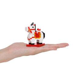 A hand holding a small, colorful, and intricate toy horse made of small building blocks.