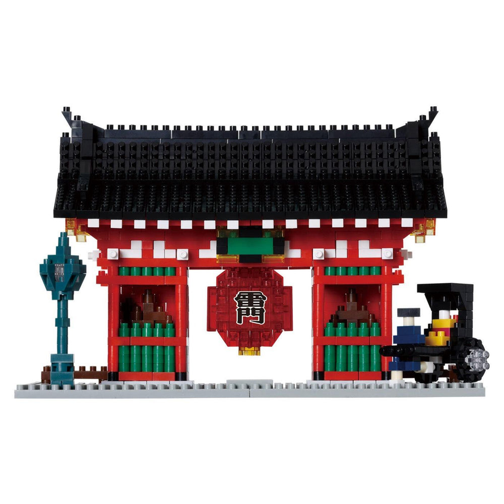 A colorful, traditional Japanese-style gate with a red roof and black accents, surrounded by a train and other elements, all made of building blocks.