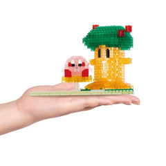 A hand holding a small, colorful, and intricate toy made of small, clear plastic pieces.