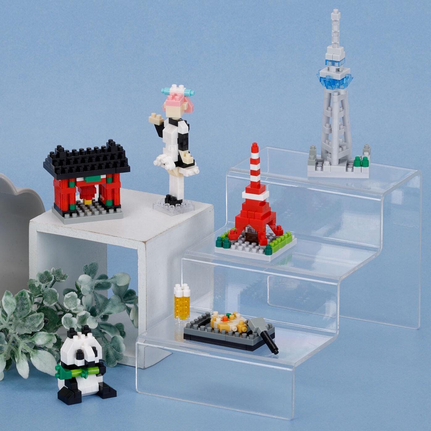 a collection of small, colorful building blocks arranged on three clear shelves against a blue background.