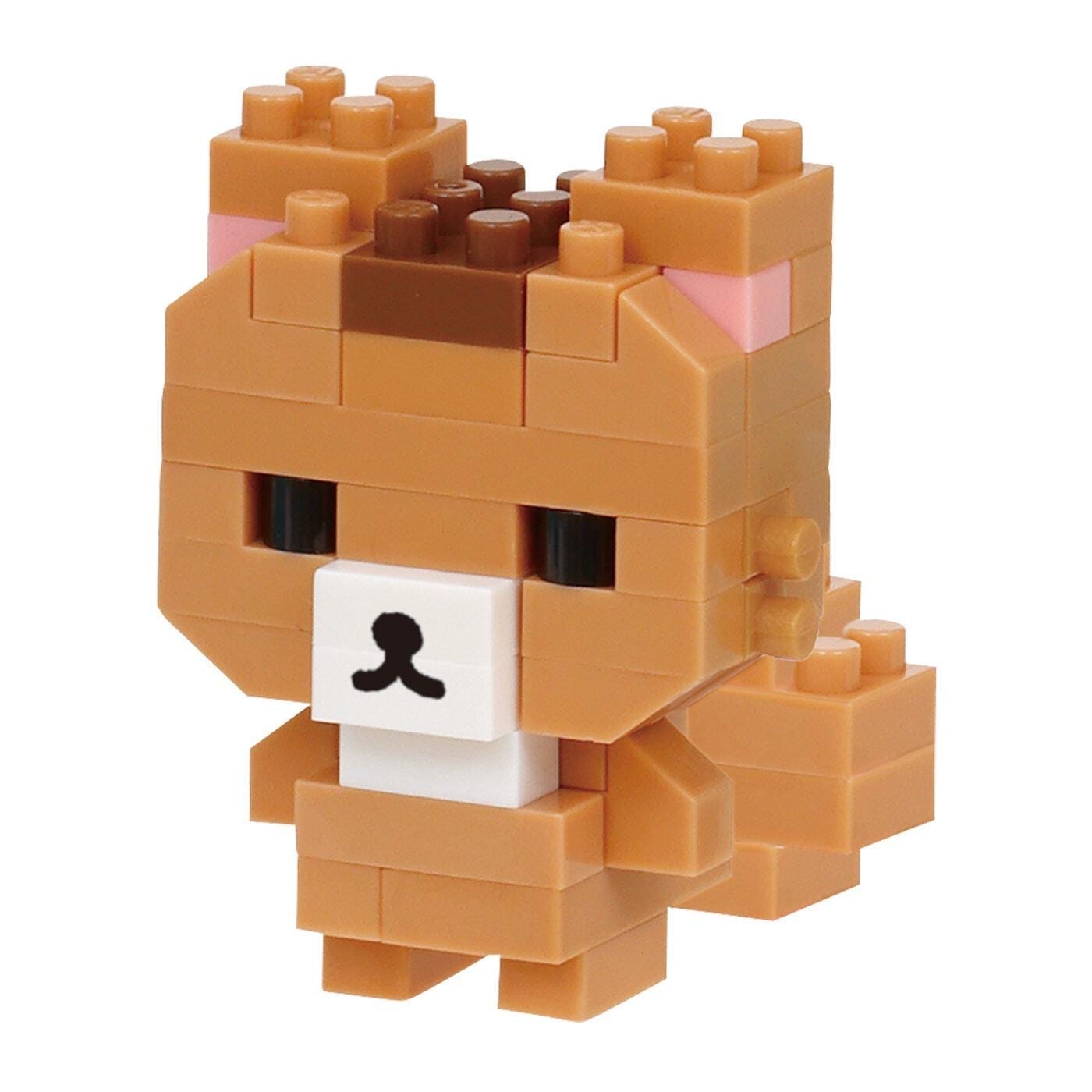 A small, brown, and beige toy made of building blocks, resembling a cute and playful character.