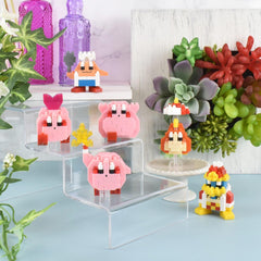 a collection of colorful, pixelated characters, including a pink pig, a yellow star, and a red and yellow robot, displayed on a shelf or stand.