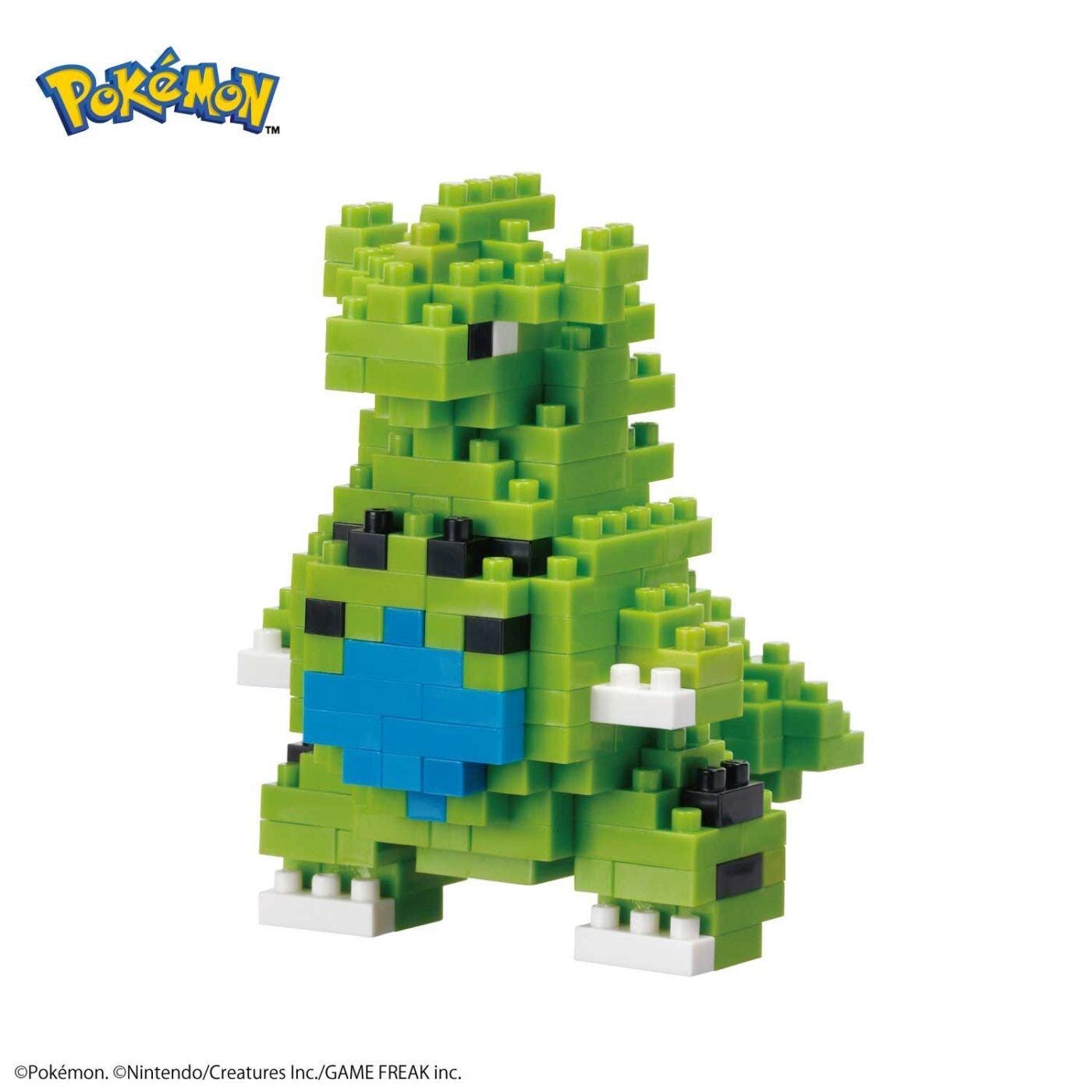 A green pixelated Pokemon character made up of small blocks, with a blue heart-shaped element on its chest.