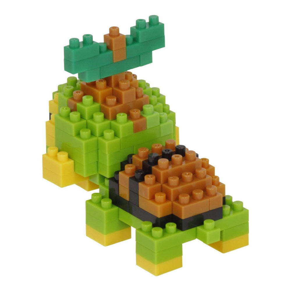 A colorful toy turtle made of building blocks in various shades of green, yellow, and orange.