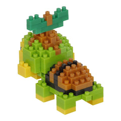 A colorful toy turtle made of building blocks in various shades of green, yellow, and orange.
