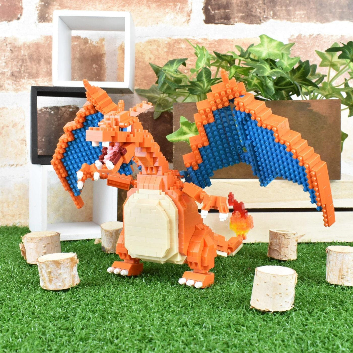 A LEGO CHAIWAN dragon figurine is posed on a grassy surface, surrounded by small tree stump decorations.