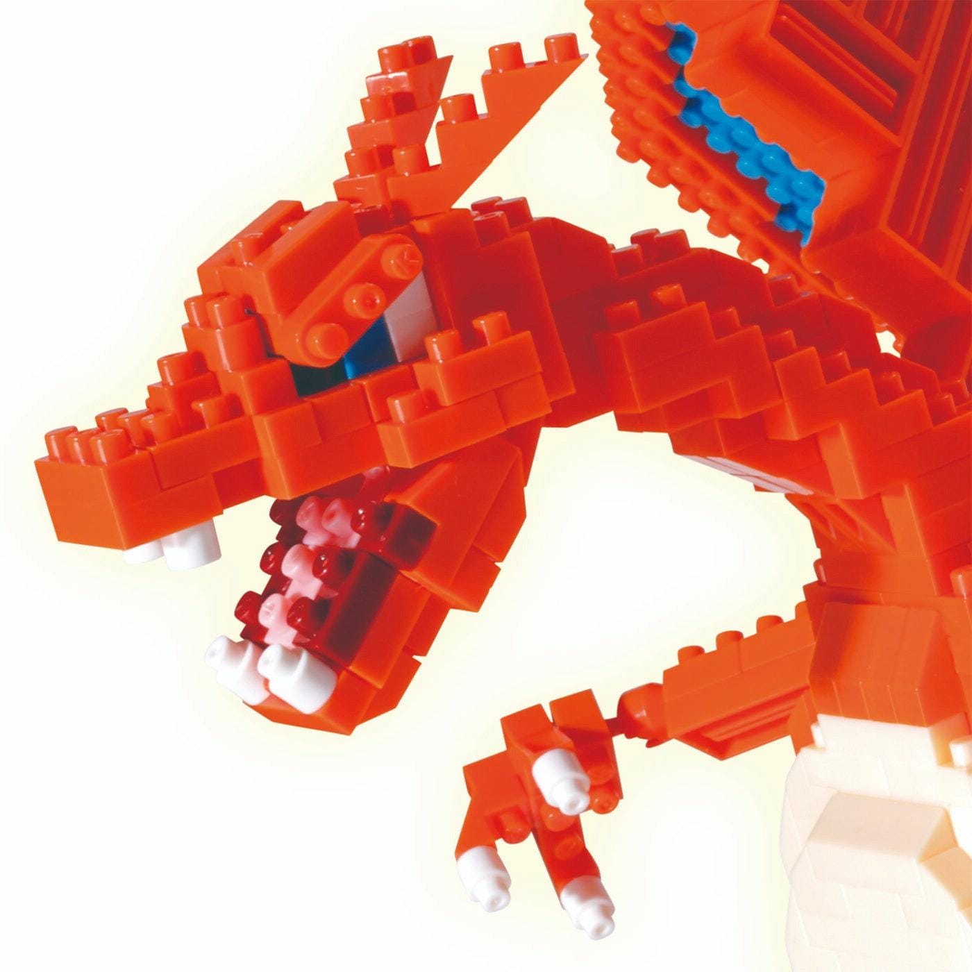 A close-up view of a red LEGO dragon-like toy, composed of numerous small LEGO bricks, with a fierce expression and sharp teeth.