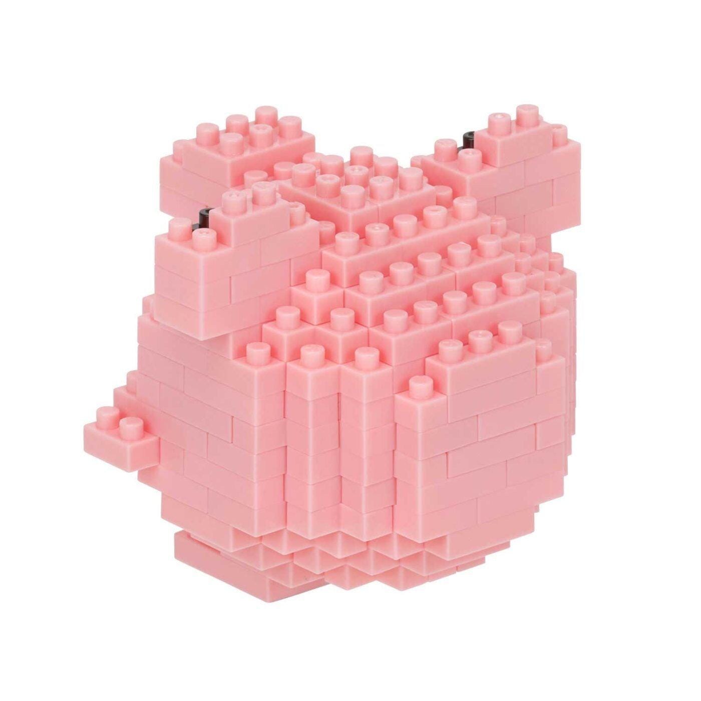 A pink, 3D-built toy piggy bank made of small, square-shaped building blocks.