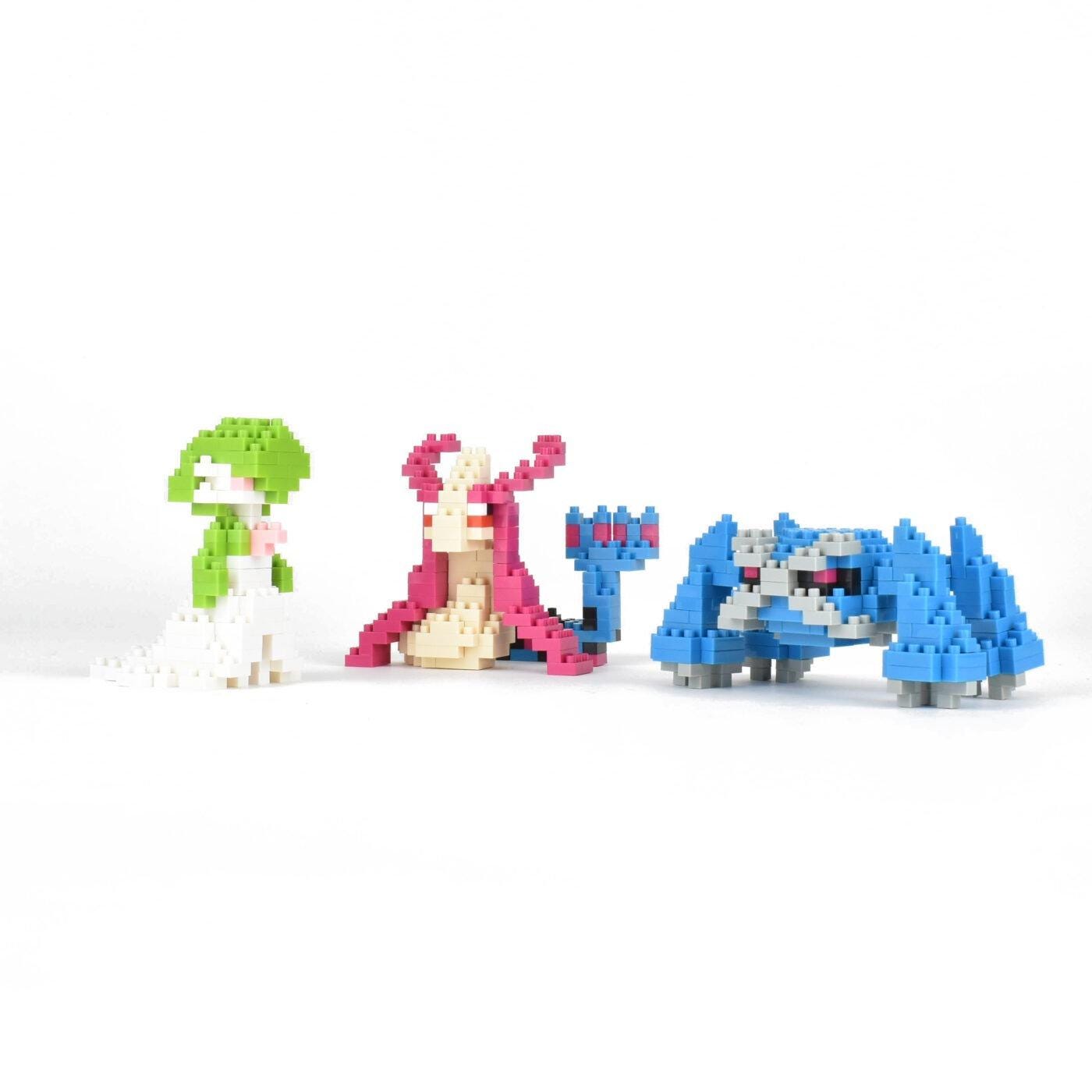 three colorful, pixelated characters, including a green character, a pink character, and a blue character, arranged in a row.