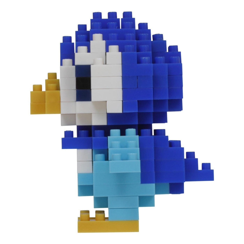 A colorful, pixelated bird made of various building blocks in blue, white, and yellow.