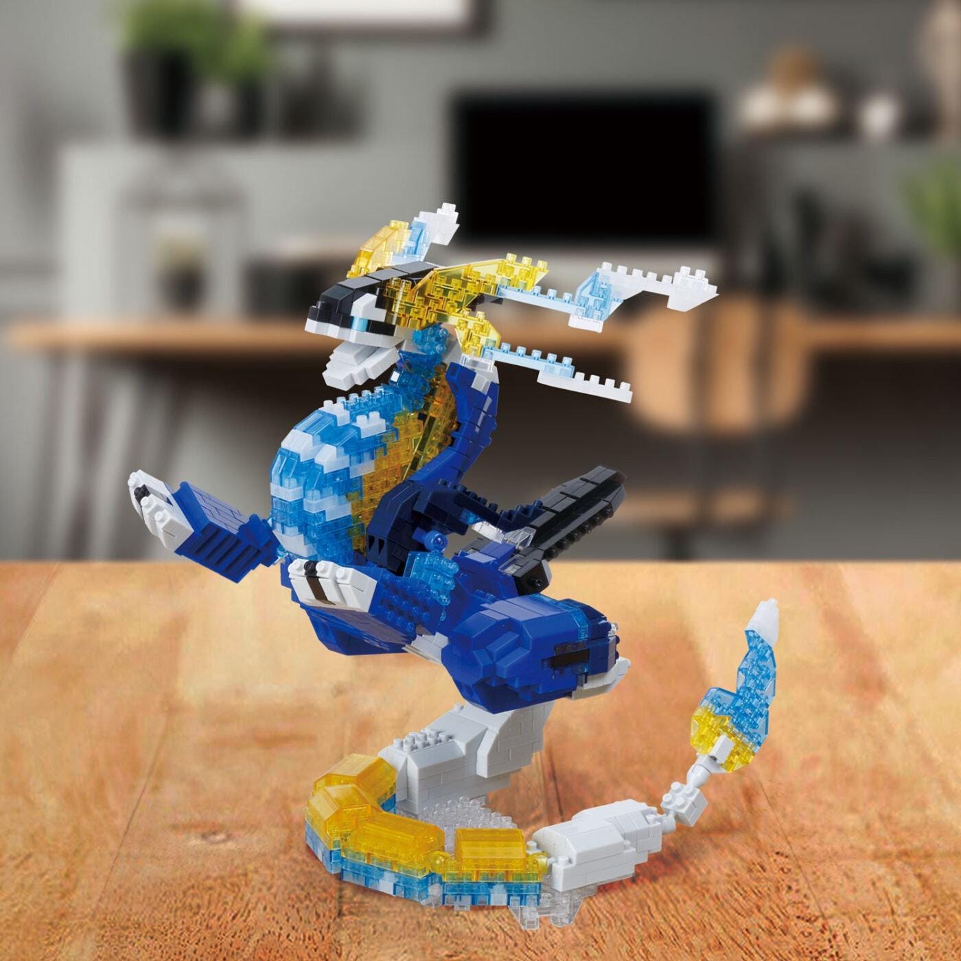 A colorful and intricate LEGO dinosaur figurine is displayed on a wooden surface, with a blurred background that suggests an indoor setting.