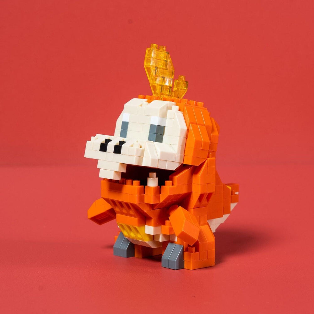 A small orange and white LEGO dinosaur figurine with a yellow crown on its head, standing on a red surface.