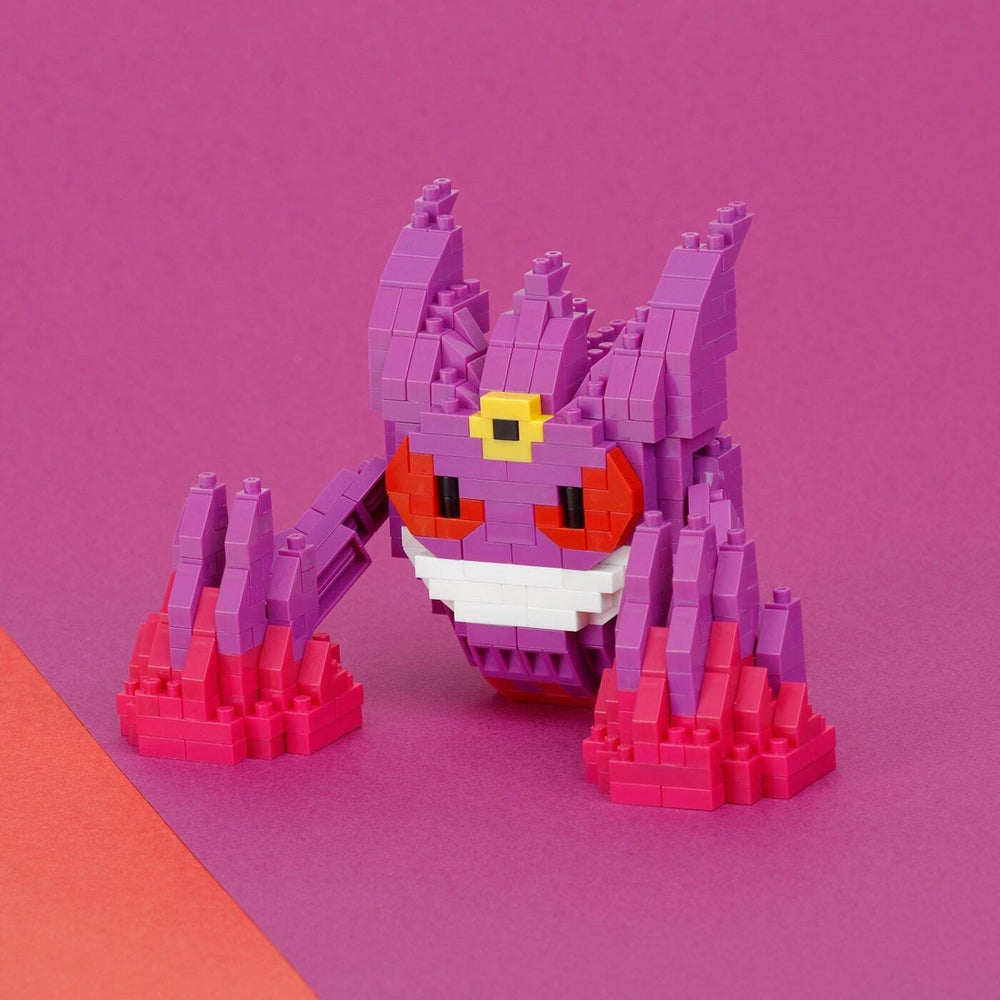 A colorful, pixelated toy resembling a character from a video game, with a predominantly purple and pink color scheme.